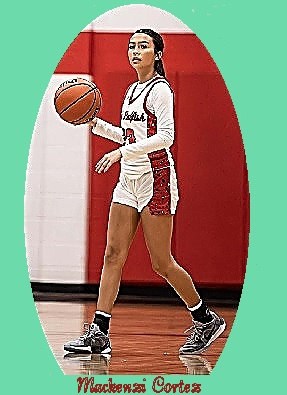 Image of Mackenzi Cortez, Austwell-Tivoli High School basketball player in Texas strolling down the court, basketball in hand near shoulder, in her scripted Redfish top.