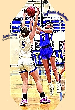LaNease Andrews in blue uniform with wide white stripe on side, up in the air shooting over #5 of Bakah Scott of Zanesville Maysville, February 12, 2025 Division IV Sectional, Maysville  won 54-48.