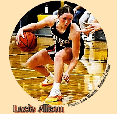Lacie Allison, girl basketball player on the North Baltimore High School, in Ohio, crouching in a game, looking to make a play, in her black NBHS uniform.