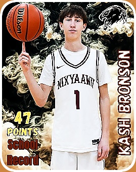 Image of Kash Brown, an Oregon boy basketball player , number 1 on Nixyaawii High twirling ball with right index finger.