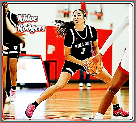 Khloe Rodgers, girls basketball player for the South Fork High Bulldogs in Florida, show legs wide in her BULLDOGS white on black uniform, looking to shoot.