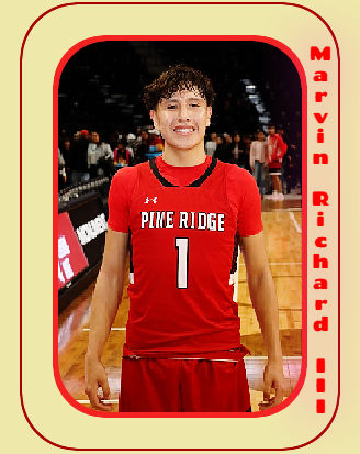 Marvin Richard III, Pine Ridge High School basketball player in South Dakota, standing in his red #1 uniform.