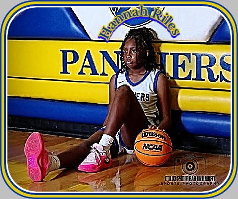 Lake City High School girls basketball player Hannah Riles sitting in front of Panthers sign on wall of gym. (South Carolina) O'Luke Photo Bar unlimited Sports Phoyographers.