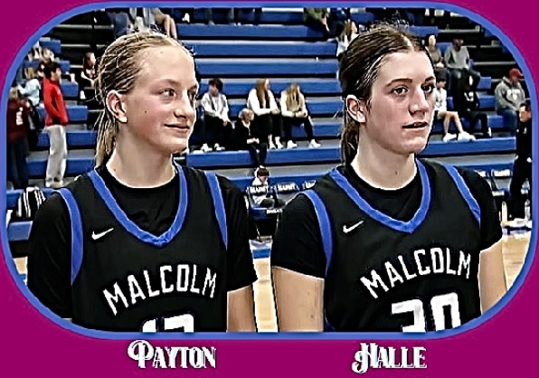 Photo of Malcolm High School's Dolliver sisters, Payton (#12, on the left) and Halle (#30, on the right), shown in black uniforms with white and blue, sitting being interviewed.