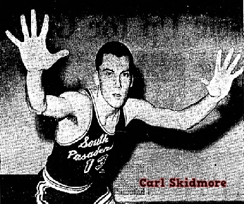 Posed image of Carl Skidmore, boys basketball player, in #13 uniform with script South PAsadena on black uniform, SOuth Pasadena High School, CAlifornia. Hands up, on defense. From the Independent Star-News, Pasadena, CAlifornia, March 25, 1967.