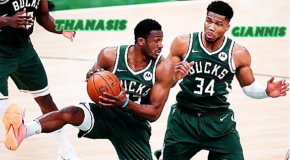 Action picture of the Antetokounmpo brothers on the Milwaukee Bucks NBA team. With right leg still up in the air, number 43, Thanasis, with the ball following a rebound, with his brother, Giannis, #34, next to him.