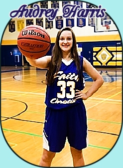 Faith Christian High School (California0's Audrey Harris, in blue unform #33, holds basketball with right hand forward.