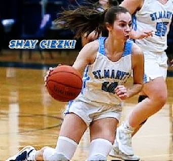 From the Buffalo News, New York state's Shay Ciezki, girls basketball player for St. Mary's of Lancaster, driving down the court with basketball in uniform #10.