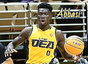 Image of Taiwanese basketball player Mohammad Al Bachir Gadiaga, “Abbasi”.  Shown from waist up, in action, with ball, in yellow DEA uniform jersey, numer 0.