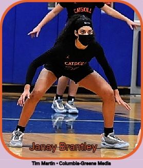 Image of Janay Brantley, on defense, wide stance, in all black uniform. Plays for the Catskill Cats high school basketball tea. CATSKILL in red lettering on the  Image: Tim Martin, Columbia-Greene Media.