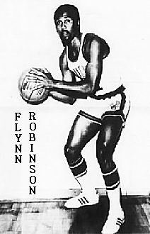 Picture of Flynn Robinson, in uniform, posing with basketball, University of Wtoming. From the Casper Star-Tribune, Casper, Wtoming, December 30, 2013.