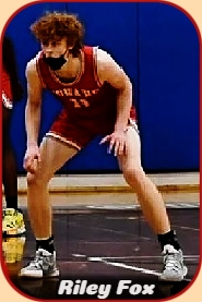 Riley Fox, Conard High School (Connecticut) boys basketball player, on defense in red #11 uniform, with black mask down.
