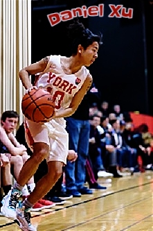 Number 10, Daniel Xu, basketball player on the York High School Falcons team in Ca;lifornia, shown charging across court.