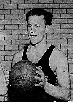 Photo of Pete Zarry, boy basketball player Pete Zarry, Vic High School, Victoria, British Columbia, posing with basketball in front of brick wall. From the Victoria Daily Times, Victoria, B.C., Canada, February 2, 1951.