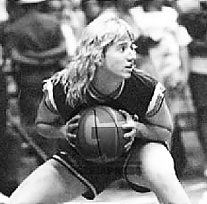 Black and white photo from 1989 game where Karina Rodriguez scored 48 points. Crouching with ball, looking to her left looking to pass the basketball for Banco Zaragozano. May 14, 1989.