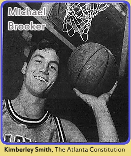 Photo of basketball player Michael Brooker, Brentwood High School, Georgia, posing under basket, holding ball up with his left hand. Photo by Kimberly Smith, The Atlanta Constitution, February 2, 1996.