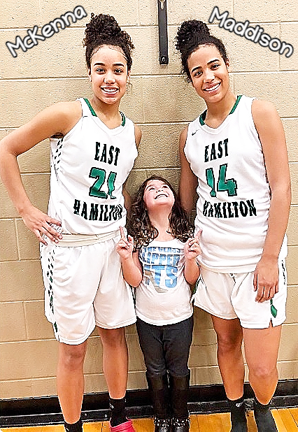 Sisters McKenna (#21) and Maddison (#14) Hayes, East Hamilton basketball players in Tennessee, 2018, standing with little sister in white uniforms.