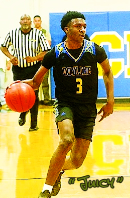 Image of Jamaria (Juicy) Clark, Louisiana boys basketball player for Doyine High School, shown dribbling, looking to make a pal, in his black uniform with yellow lettering, #3.