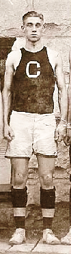 Herman (Buzz) Sayger, Cukver High basketball play who scored 113 point in one game in 1913, standing with big C on uniform center.