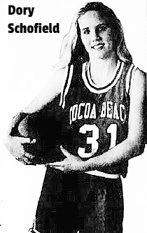 Photo of girls basketball player Dory Schofield, Cocoa Beach High School (Florida), cradling a basketball with both hands against her right hip, wearing uniform #31. From Florida Today, March 29, 1992