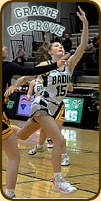 Ohian girls basketball player Gracie Cosgrove, #15, in white uniform, going up for a lay-up for the Badin High School Rams.