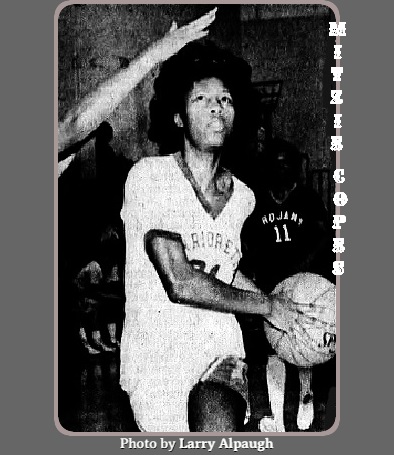 Image of Mitzie Copes, Pokomoke High School, scoring two of her 48 points in the Divisional semifinal game, running with the basketball in her #21 WARRIORETTE uniform, basket to her left side, going in for the score. From The Saily Times from Salisbury, Matyland, February 28, 1984. Photo by Larry Alpaugh.