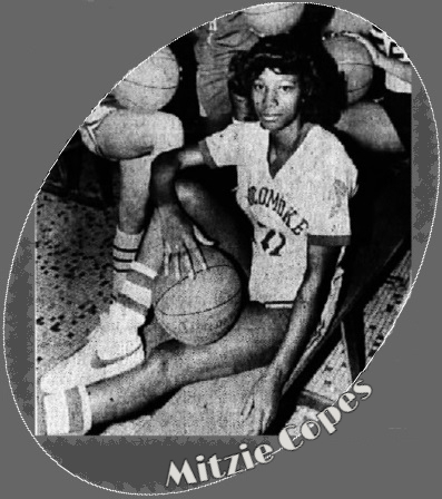 Maryland basketball player Mitzie Copes, Pokomoke High school, sitting on ground, in uniform, legs out, right knee up, basketball resting there with her right hand on it as well. Cropped from a photo of the Bayside Conference Southern Division girls all-stars selections, from The Daily Times, Salisbury, Maryland, April 1, 1984,