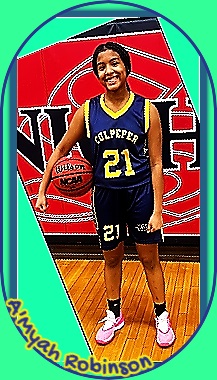 Pictured is A'myah Robinson, Culpeper High School, Virginia, girls basketball player in blue uniform with yellow trim, #21, standing, posing, with basketball on her right side held by her right forearm.
