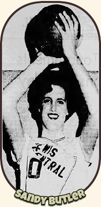Sandy Butler, Lewis Central High School basketball player in Iowa, holding ball with both hands above her head. From the Council Bluffs Nonpareil, Council Bluffs, Iowa,March 8, 1964.