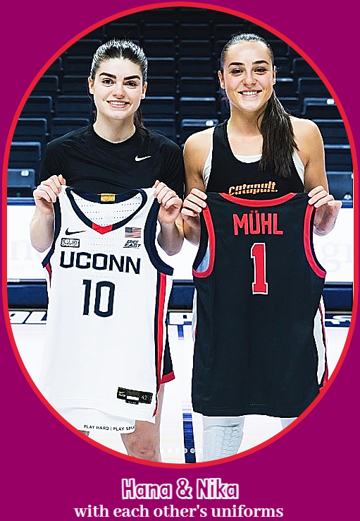 Photo of sisters Hana and Nika Muhl, holding each other's uniform jerseys, Nika (right) is on UConn and Hana (left) on Ball State.