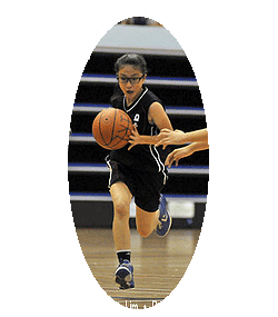 Image of Jayne Chan, basketball player on the Convent of the Holy Infant Jesus (CHIJ) Secondary School (Singapore), girls basketball player driving the ball upvourt directly at our vantage point. Photo copyright Vanessa Lim / /Red Sports.