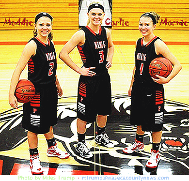 Maddie, Carlie and Marnie Wagner, sisters who playe basketball for New Richland-Hartland-Ellendale-Geneva Hish School team, the Panthers. Posing with basketballs at midcourt. Photo by Miles Trump mtrump@wasecacountynews.com .