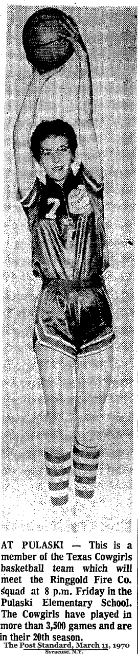Image of a tall Texas Cowgirl, #7 (maybe Elvera Neuman), holding the ball high over her head from The Post Standard, March 13, 1970. 'AT PULASKI -- This is a member of the Texas Cowgirls basketball team which will meet the Ringgold Fire Co. squad at 8 p.m. Friday in the Pulaski Elementary School.  The Cowgirls have played more than 3,500 games and are in their 20th season.'.
