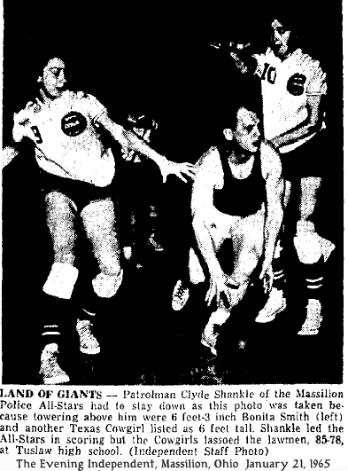 Action shot from The Evening Independent, Massillon, Ohio, JAnuary 21, 1965, titled LAND OF GIANTS--Patrolman Clyde Shankle of the Massillon Police All-Stars had to stay down as this photo was taken because towering above him were 6 feet-3 inch Bonita Smith (left) and another Texas Cowgirl listed as 6 feet tall. Shankle led the Akk-Stars in scoring but the Cowgirls lassoed the lawmen, 85-78, at Tuslaw high school. (Independent Staff Photo)