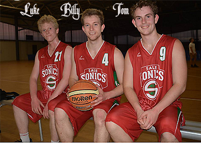 Photo of the three Hughes brothers, Luke (#21), Billy (#4) and Tom (#9), sitting in red Sales Sonics uniforms, Billy holding basketball. From online Gippsland Times and Maffra Spectator.