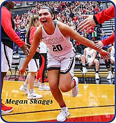 Megan Skaggs, women's basketball player for Central Missouri University, in her white JENNIES uniform, celebrating, giving high fives to others as shecelebrates after a January 2019 game.