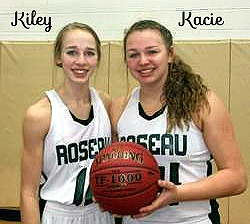 Two Borowicz sisters, in white Roseau High (Minnesota) uniforms with basketball. #11 Kiley and #14 Kacie.