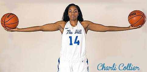 Image of Charli Collier, girls basketball player in Texas for Barbers Hill High, holding two basketballs with both arms extended, wearing white uniform with blue script reading The Hill and the number 14 on the jersey.