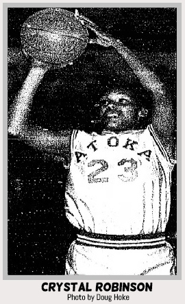 Image of Oklahoman girls basketball player, Crystal Robinson, in her Atoka High School uniform, number 23, arms overhead with ball ready to shoot to our left. From The Daily Oklahoman, Oklahoma City, Oklahoma, staff photographer: Doug Hoke.