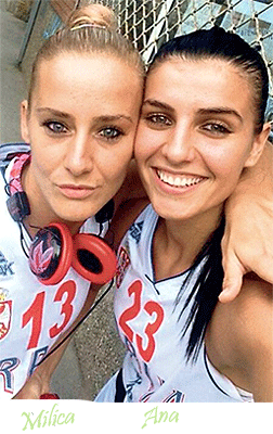 Image of sisters Ana and Milica Dabovic, basketball players for the Serbian women's national basketball team. Smiling cheek to cheek, Ana, blonde, and Milica Dabovic.