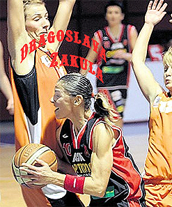 Image of Bosnian female basketball player, Dragoslava Zakula, Krajisnik guard. dribbling through a forest of taller opponents, with their hands held high
