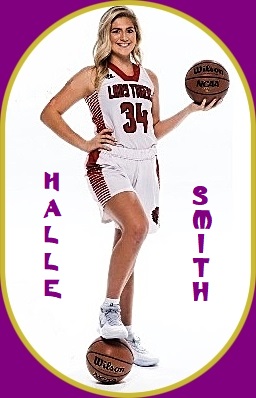 Image of girls basketball player, Halle Smith, Belle High School (Missouri), posing in her white Lady Tigers, #34, uniform, holding a basketball in left hand, right hand on hip, right foot resting on a second basketball on the ground.