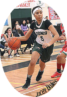 Image of Jacey Bailey, Burnaby Mountain Secondary School girl's basketball player, with ball in action shot wearing Lions number 5 white uniform.