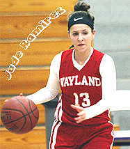 Image of Jade Ramirez, in red Wayland Academy Wildcats basketball uniform, number 13, bring the ball upcourt.