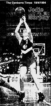 Image of Jodie Murphy up in the air, shooting a jump shot as #7 on the Canberra Capitals in the W.N.B.L. against the Brisbane Blazers, April 18, 1994. From The Canberra Times, 19 April, 1994. Picture: Gary Schafer.