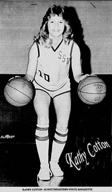 Picture of Kathy Cotton (Clarke) palming two basketballs, wearing her later Southwestern State (Okla.) Savagettes uniform. From The Durant Daily Democrat, Dyrant, Oklahoma, February 5, 1998.
