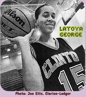 Mississippi girls basketball player, Latoya George, Clinton High School, holding basketball up and looking down at camera, in uniform number 15. Pjoto by Joe Ellis, from The Clarion-Ledger, Jackson, Mississippi, October 17, 2001.