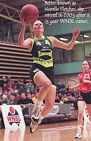 Image of Narelle Fletcher (ne McConnell) in a green uniform, going up for a lay-up.