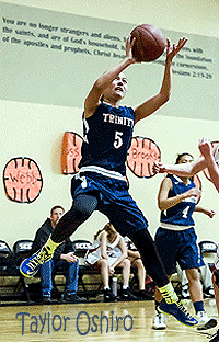 Trinity Classical Academy basketball player, Taylor Oshiro, number 5, up in the air taking a shot.