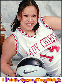 Diana SoundingSides, Wyoming Indian School basketball player, number 14, posing with basketball.